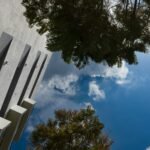 looking up at a tall building with a sky in the background